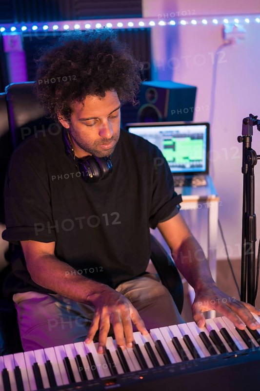 Vertical top view of a pianist performing in studio production while recording music