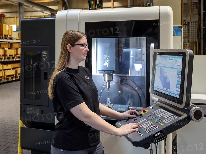 Oberhausen, North Rhine-Westphalia, Germany, Trainee woman in metalworking. Trainee cutting machine operator at a CNC machine tool in the MAN training centre. MAN Energy Solutions is a traditional company in the Ruhr region. Around 2, 000 employees build and develop compressors and turbines at the 250-year-old site in Oberhausen
