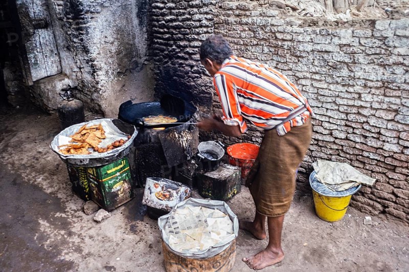Traders preparing snacks in a dark alley in Zebid, Zabid, Yemen 1998 UNESCO World Heritage Site