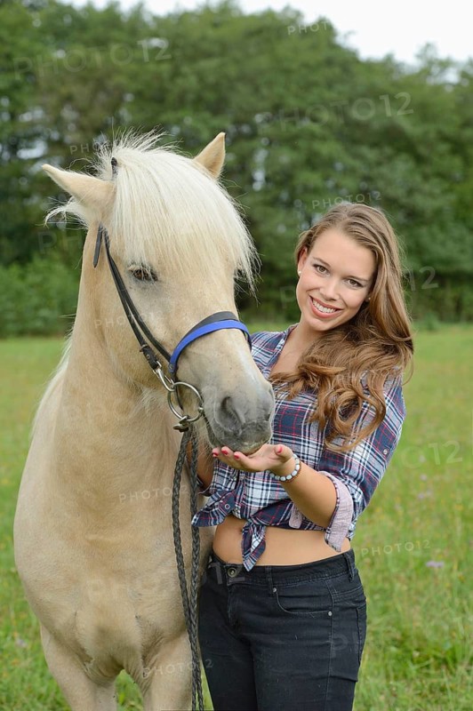 Young woman with a Icelandic horse on a meadow, Germany