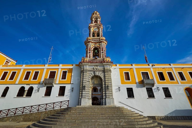 Historic building with baroque church tower in front of clear blue sky, Holy Week, Bay of Panormitis, Panormitis Monastery, Symi, Dodecanese, Greek Islands, Greece