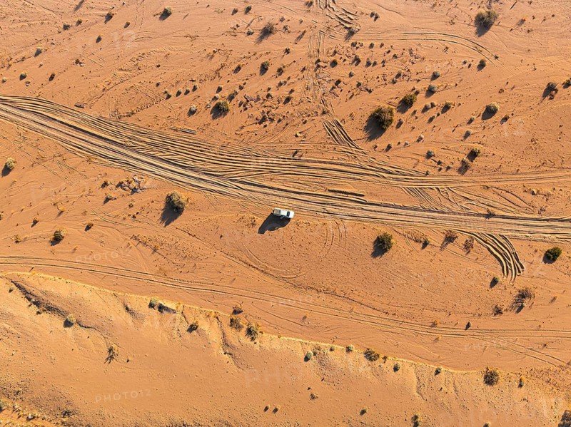 Aerial view, lonely road with offroad car, desert landscape, Erongo, Damaraland, Namibia