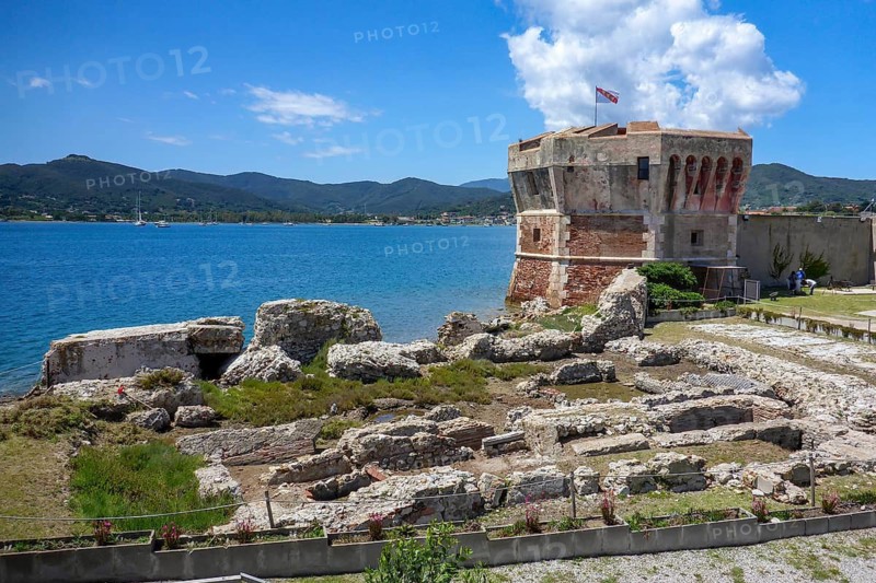 View of part of open-air museum of Portoferraio with ruins of Roman Villa Romana della Linguella in front, behind historical tower watchtower Torre del Martello Hammerturm, headland Linguella, Portoferraio, Elba, Tuscany, Italy