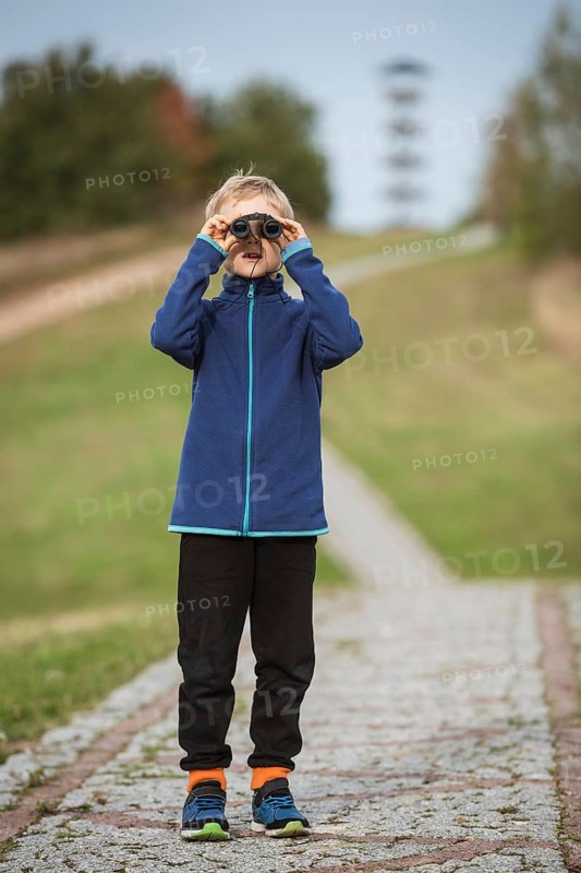 Young boy looking through the binoculars