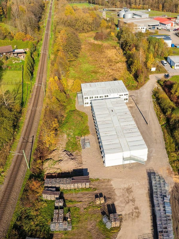 Aerial view of an industrial area next to railway tracks with autumn landscape, refugee accommodation Beermiß, Calmbach, Black Forest, Germany