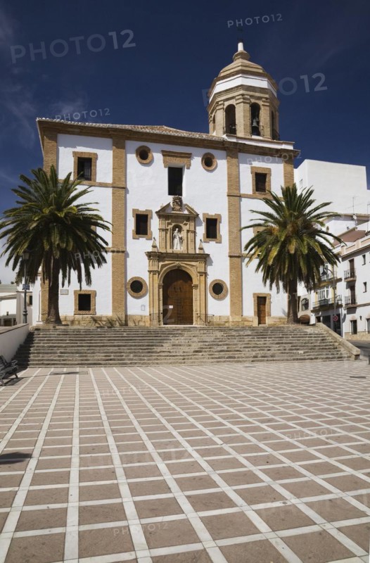 La Merced or Church of Our Lady of Mercy facade framed by Phoenix dactylifera, Date trees, Ronda, Spain