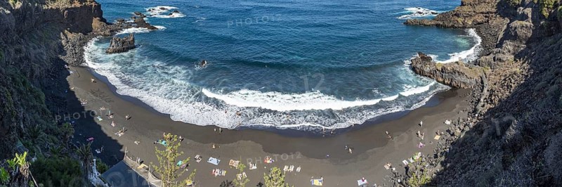 The lava beach lined with bathers, Playa del Bollulo, near Puerto de la Cruz, Tenerife, Canary Islands, Spain Europe