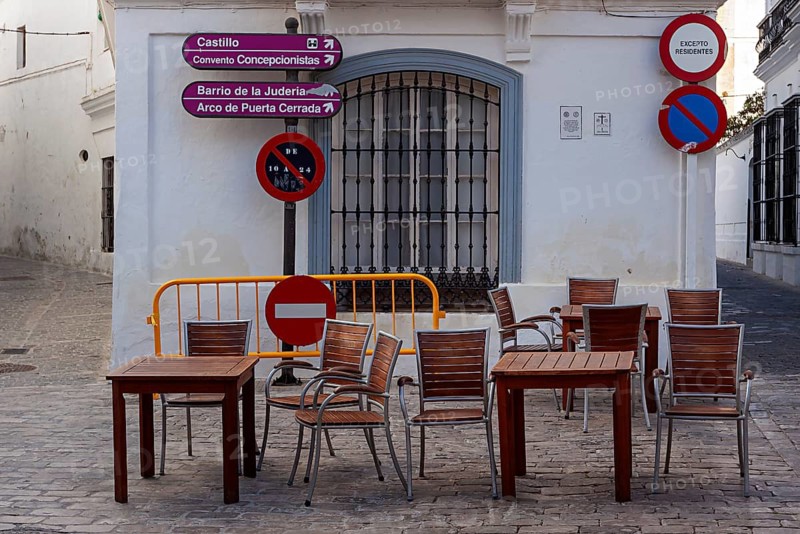 Table and chairs in the outdoor catering area, Vejer, Andalusia, Spain