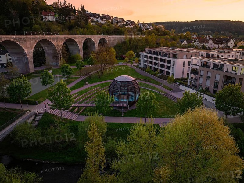 Aerial view of a wooden ball in the park, surrounded by trees and near an aqueduct at sunset, Forstkugel, Nagold Black Forest, Germany