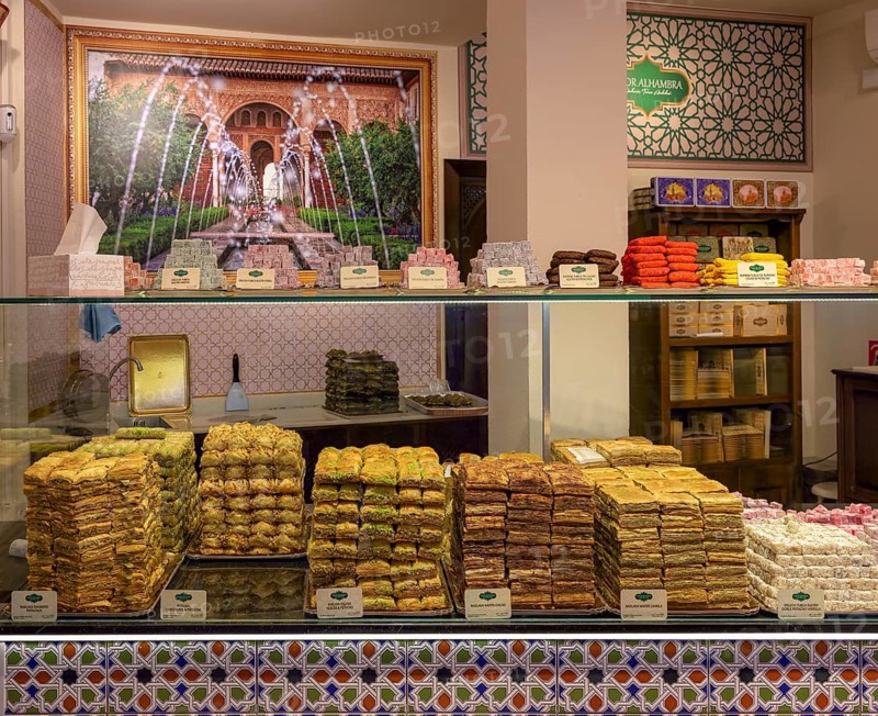 Colourful sweets in a shop window decorated with oriental tile patterns, Cordoba, Spain