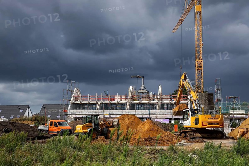 Bottrop, North Rhine-Westphalia, Germany, Housing construction in new development area. Dark clouds over new development neighbourhood, residential project in Bottrop-Kirchhellen with 60 semi-detached and terraced houses