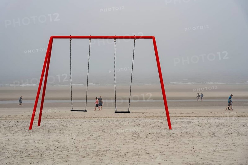 North Sea island of Langeoog, early summer, shortly after the first easing of the lockdown in the Corona crisis, foggy weather, still quite few tourists on the beach, children's swing, Lower Saxony, Germany