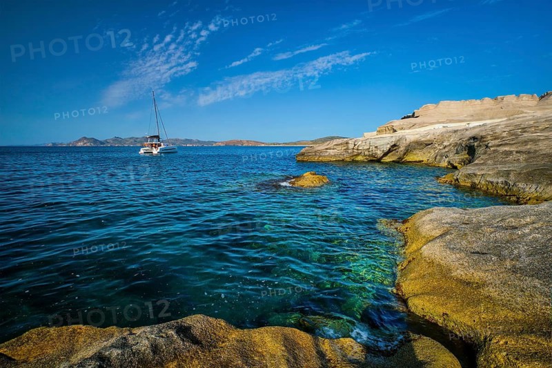 Yacht boat in Aegean sea at white rocks of Sarakiniko Beach, Milos island, Greece