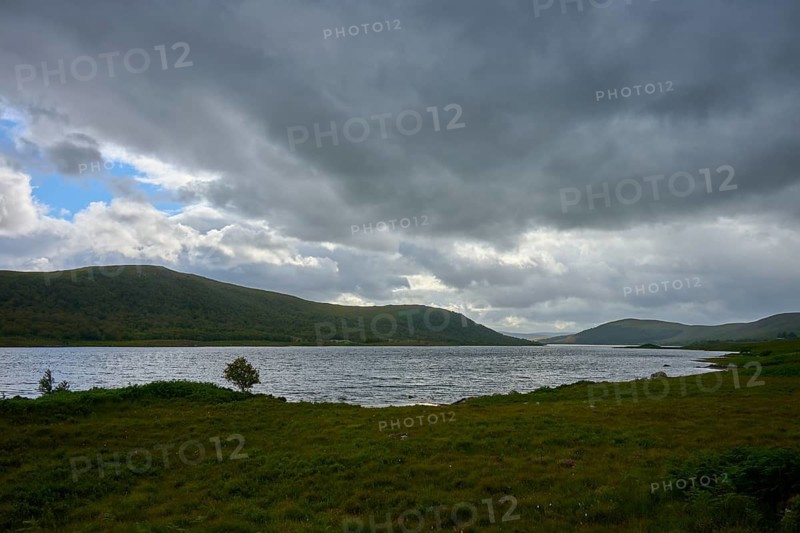 Extensive lake with rolling landscape and cloudy sky, Loch Naver, Lairg, Scotland, United Kingdom, Great Britain