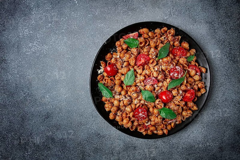 Tuscan pasta with smoked paprika and basil, parmesan cheese, Italian traditional cuisine