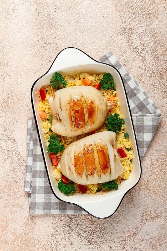 Stuffed squid carcasses, baked in the oven, fried, with couscous, top view, homemade, no people