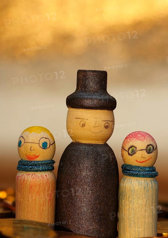 Three wooden cones standing in euro coins, North Rhine-Westphalia, Germany