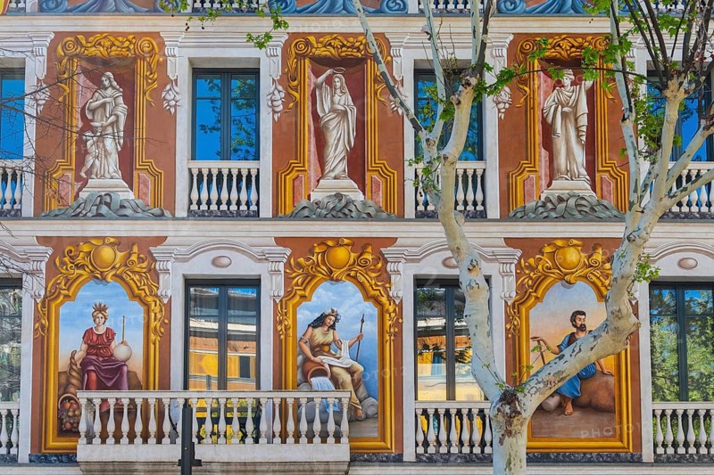 A façade painted with antique motifs on a house in Barcelona, Spain