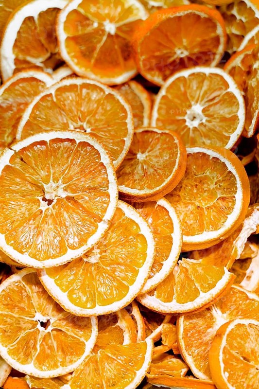 A close up view of dried orange slices showcasing their vibrant color and textured surface, ideal for culinary purposes or as natural decorative elements in various settings