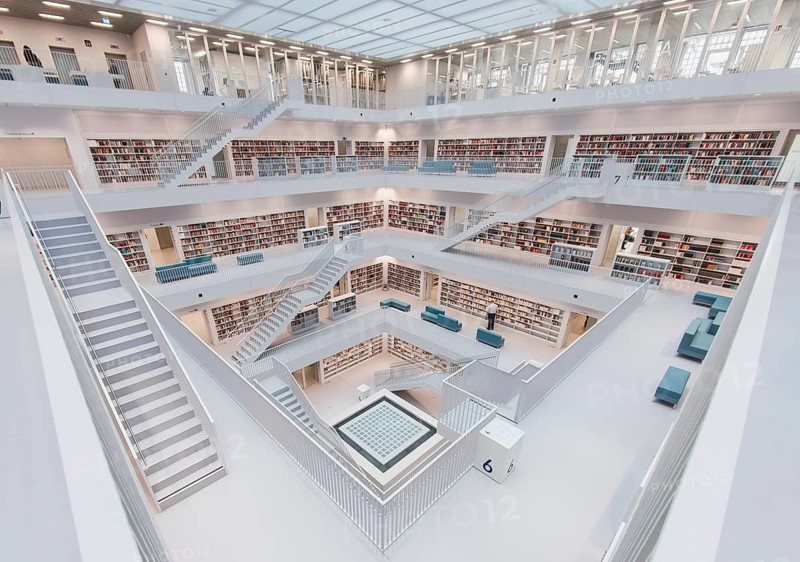 Modern, bright library with open staircases and many bookshelves in a symmetrical arrangement, public library am Mailänder Platz, empty, Stuttgart, Germany