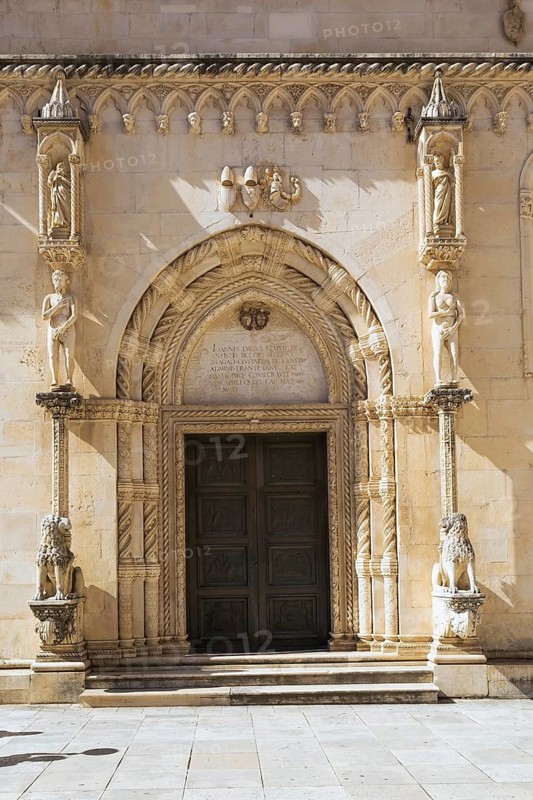 Arched entrance of the Cathedral of Saint James with decorative architectural details and carved lion sculptures, Sibenik, Croatia