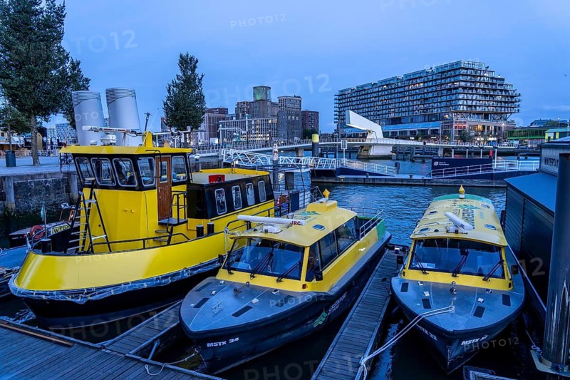 Mooring of the water taxi, behind it the former Fenix warehouse from 1923, destroyed in the war, renovated in 2019, converted into a residential and commercial building, with hotel, flats, restaurants, offices, on the Rijnhaven, Rijnhavenbrug, bridge, Rotterdam, Netherlands