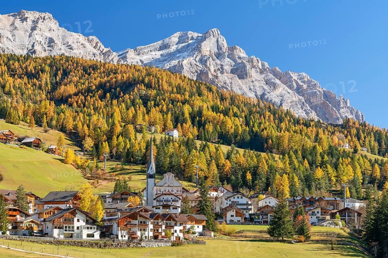 Church of St. Leonhard in Abtei, Alta Badia, Heiligkreuzkofel, autumn, larches, blue sky, Dolomites, Bolzano, Italy
