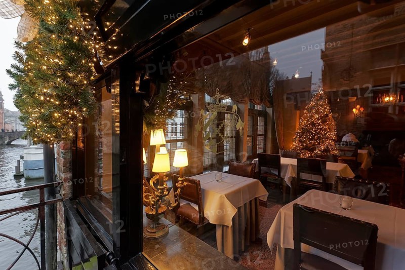 Boutique hotel Relais Bourgondisch Cruyce, view of the illuminated dining room with Christmas tree, Bruges, West Flanders, Flanders, Belgium