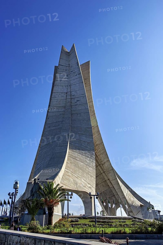 Concrete monument with a modern design against a blue sky, the national independence monument in Algiers Algeria