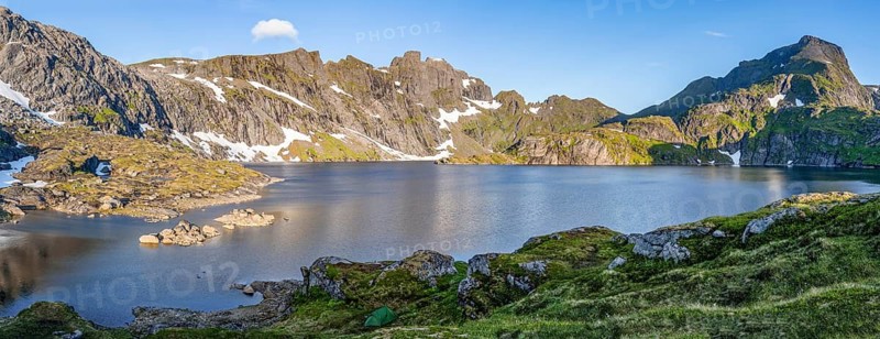Mountain landscape with steep rocky peaks and lake Tennesvatnet, in the back peak of Hermannsdalstinden, Moskenesøya, Lofoten, Nordland, Norway