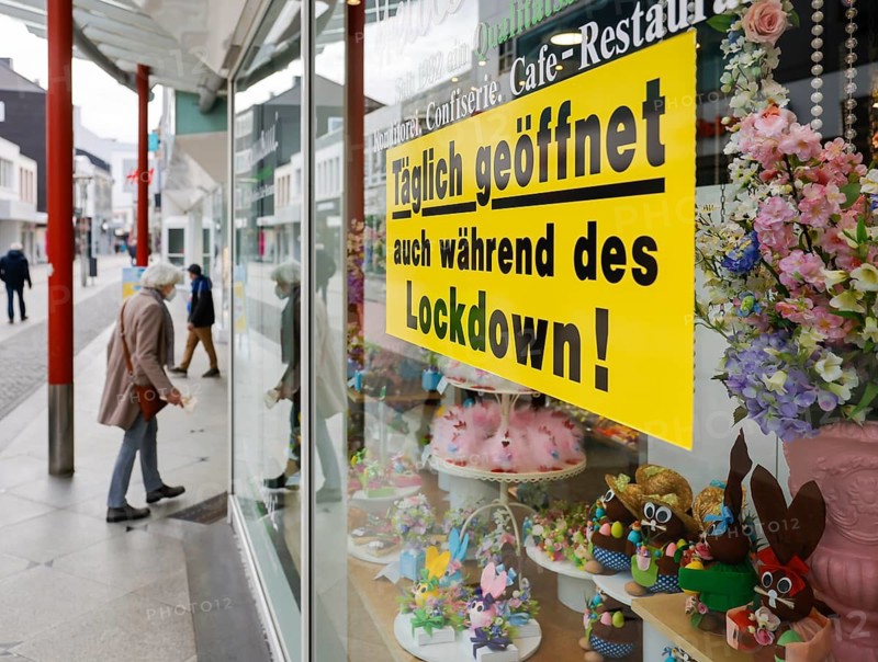 Krefeld, North Rhine-Westphalia, Germany - Krefeld city centre in times of the corona crisis during the second lockdown, a cafe restaurant advertises in the shop window with OPEN DAILY EVEN DURING THE LOCKDOWN, most shops are closed, only a few passers-by are walking on Hochstraße, the main shopping street