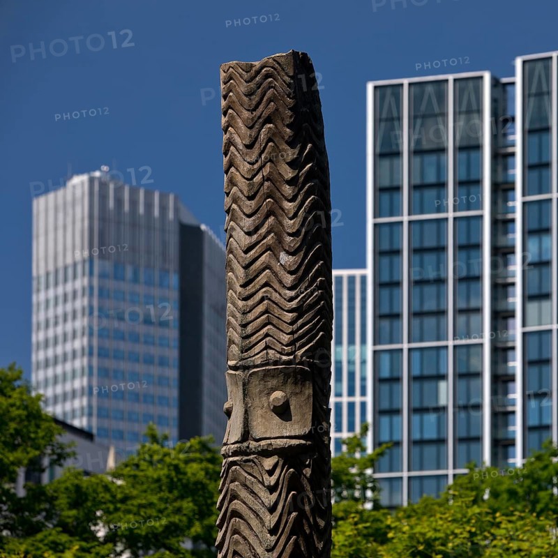 Stele made of carved wood from Papua New Guinea at the Weltkulturen Museum in front of skyscrapers, Kontrast der Kulturen, Frankfurt am Main, Hesse, Germany