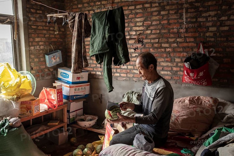 Worker Yang Zhao Bin at his sleeping place, the workers live in the respective buildings where the ducks are kept, a small room is provided for them there. There is one labourer for every two duck houses Ducks at the rearing station, Jiang Su Salted Duck Farming Co. Ltd, Xiang Shui County, China