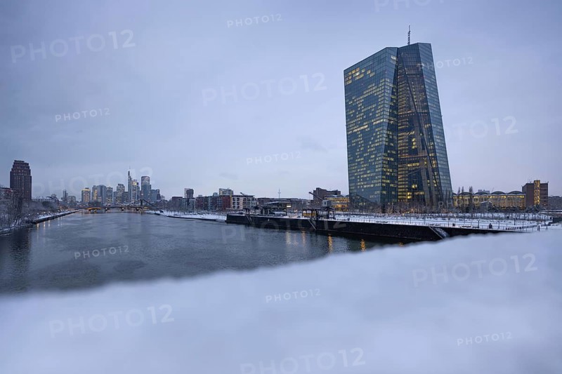 Snow lies along the banks of the Main from the European Central Bank (ECB) to the Frankfurt banking skyline, Osthafen, Frankfurt am Main, Hesse, Germany