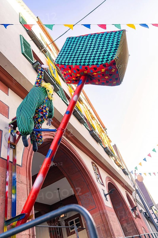 An imaginatively decorated doll figure hangs from a building in the town, Fasnet, Weil der Stadt, Böblingen district, Germany