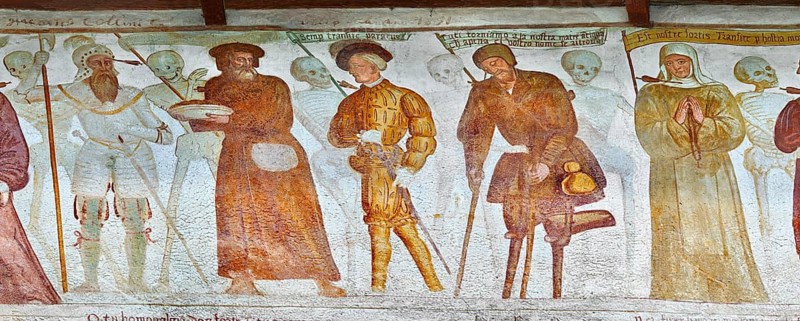 The Church of San Vigilio in Pinzolo and its fresco paintings “Dance of Death” painted by Simone Baschenis of Averaria in1539, Pinzolo, Trentino, Italy. Nobility, Knights and a beggar pierced with an arrow from the skeletons that are either side o