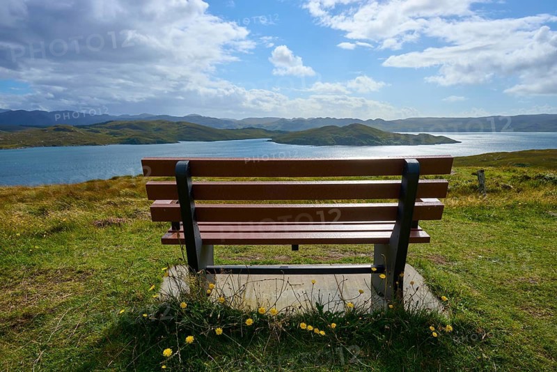 Wooden bench with views over tranquil lake and hills, Loch Torridon, Balgy, Strathcarron, Scotland, United Kingdom, Great Britain