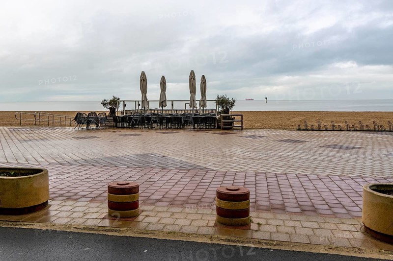 Winter break, closed terraces of catering establishments on Zeedijk-Knokke, beach promenade in Knokke-Heist, on the North Sea beach, dreary winter day, mostly apartment buildings with rental or condominiums, high-rise buildings on the street, Belgium