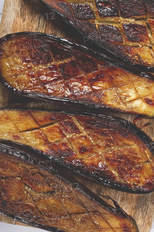 Sliced fried eggplant, on a chopping board, top view, homemade, no people