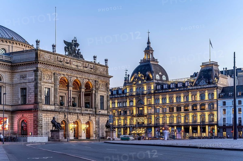 Det Kongelige Teater Royal Danish Theatre and the Magasin du Nord department stores' on Nytorv Square at dusk, Copenhagen, Denmark