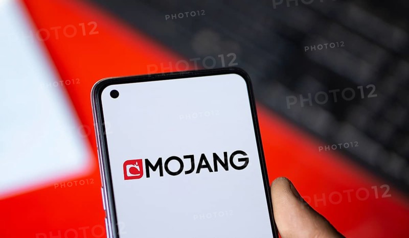 Mojang logo is displayed on smartphone. Mojang Studios is a Swedish video game developer.