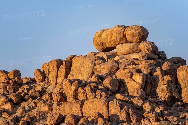 Round spherical rocks, stacked into hills, in the evening light at sunset, Brandberg, Damaraland, Erongo, Namibia