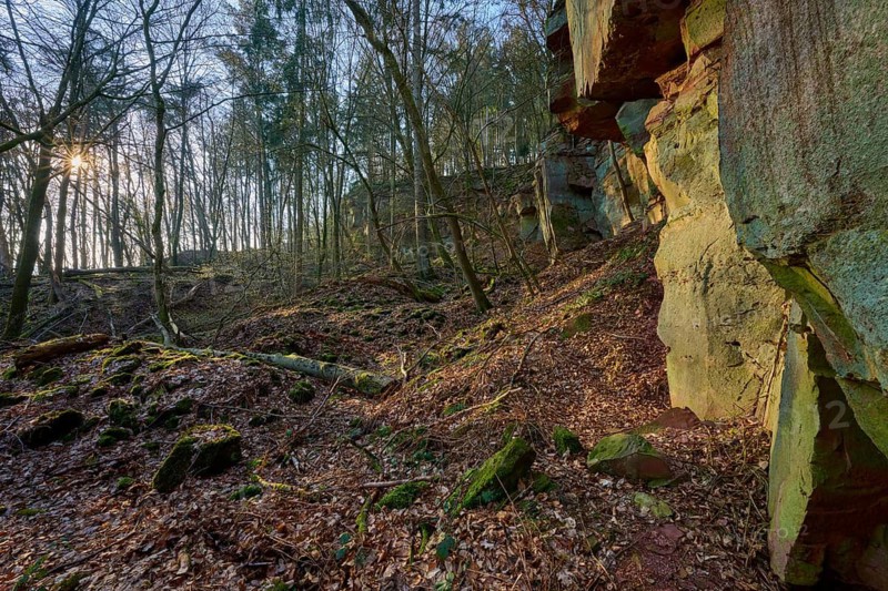 Rock formation in the forest with incoming sun rays and moss-covered soil, old quarry, Boxtal, Main-Boxtal, Tauber district, Baden-Württemberg, Dorfprozelten, Main, Spessart, Bavaria, Germany