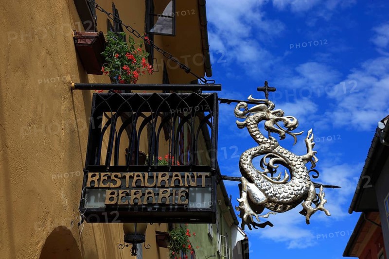 Romania, Restaurant Berarie, restaurant sign with dragons in the historic old town of Sighisoara, German Sighisoara, town in Mures district in Transylvania, UNESCO World Heritage Site