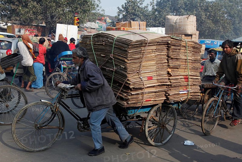 New Delhi, India, 14.01.10 - A man pushes his bicycle loaded with bags, India