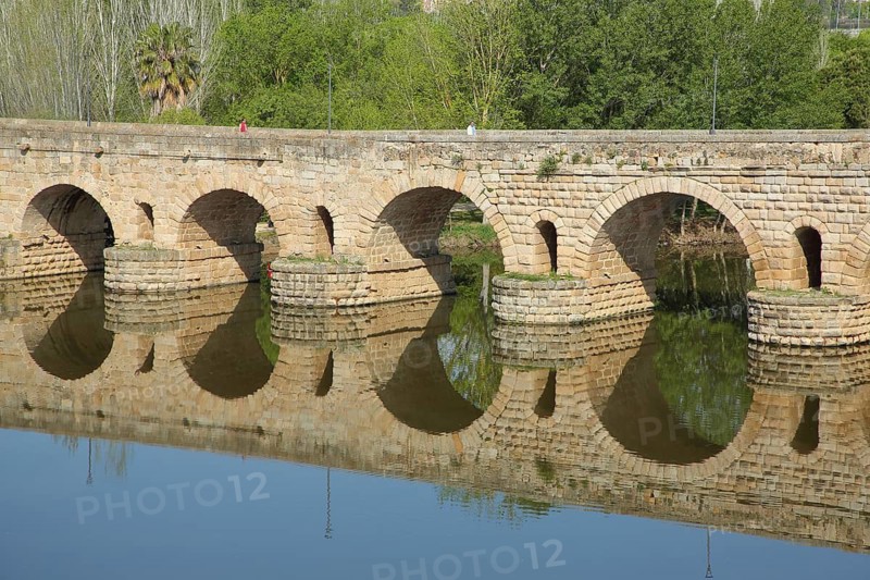 UNESCO Puente Romano, Roman bridge, stone arch bridge, part of the Roman city of Emerita Augusta, reflection in the Rio Guadiana river, Merida, Extremadura, Spain