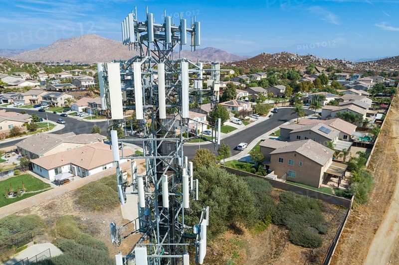 Close-up Aerial of Cellular Wireless Mobile Data Tower with Neighborhood Surrounding