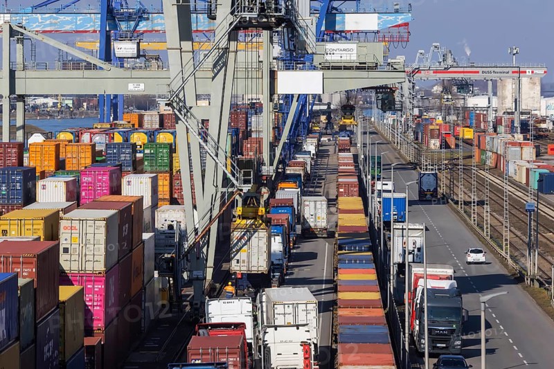 The port of Mannheim is one of Europe's most important inland ports and container terminals. Sea containers are stacked under gantry cranes waiting to be loaded onto lorries and goods trains. Mannheim, Baden-Württemberg, Germany