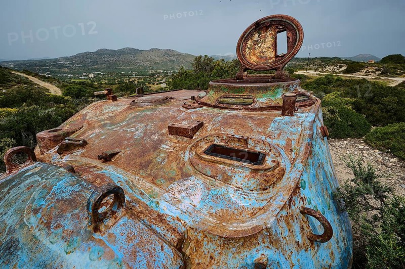Close-up of a rusty tank with an open hatch in a wide landscape, Anthony Quinn Bay, Vagies Bay, Rhodes, Dodecanese, Greek Islands, Greece