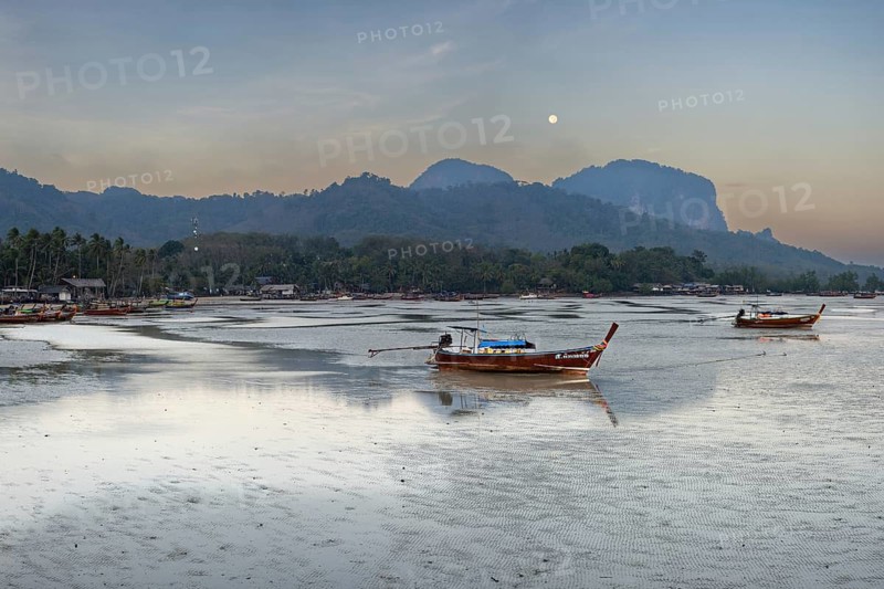 Before sunrise, longtail boats lie at low tide in the harbour at Sivalai Beach, Koh Mook Island, Satun Province, Southern Thailand, Thailand